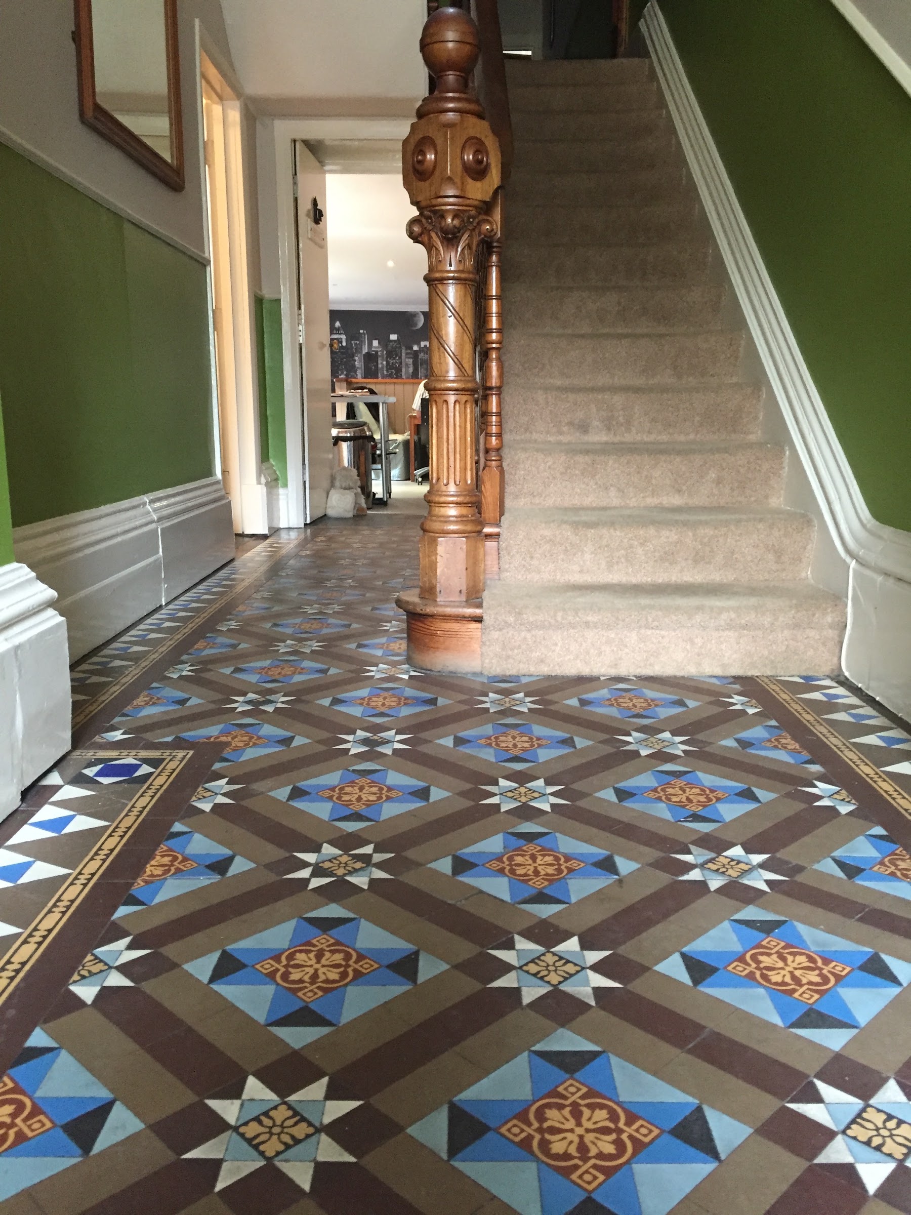 Original Victorian mosaic tiling and carved staircase at Moorgarth Guest House